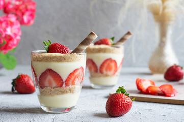 Magnolia dessert with fresh strawberries in glass cup, homemade milky dessert concept