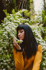 girl feeling nature smelling flowers