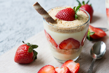 Magnolia dessert with fresh strawberries in glass cup, homemade milky dessert concept