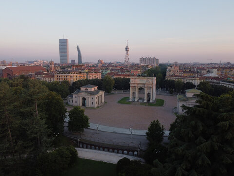 Aerial view of the Parco Sempione park on background of Milan's cityscape
