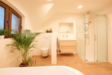 Fototapeta na wymiar Beautiful, bright bathroom in country house style, with tiles in wood look. Large bathroom in a country house, with wood and white tiles. Freestanding bath 