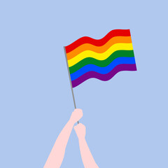 lgbt flag held by hands on light blue background