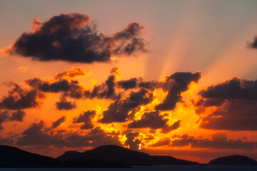 Whitsunday Islands, view from Hamilton Isand at sunrise - -hills silhouetted in beautiful orange...