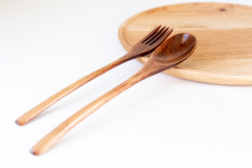 wooden fork spoon on white background, eco-friendly cutlery, biodegradable materials for living on a clean planet without plastic
