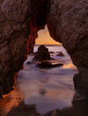 Sunset through a sea cave in Malibu.   - obrazy, fototapety, plakaty