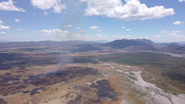 aerial shot of a fire in the middle of the desert 4l