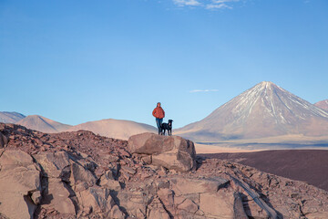 Fototapeta premium person and dog on the top of mountain