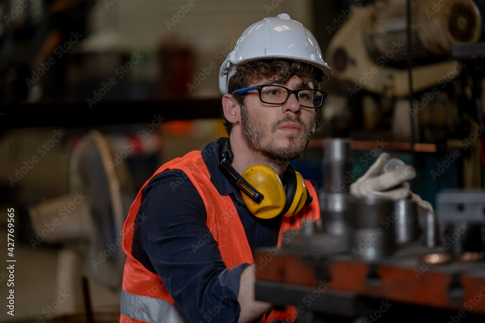 Leinwandbilder technician workers are turning iron,engineer control operating lathe grinding machine working in ind