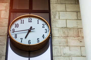 Fototapeta na wymiar Street city clock on the wall. previously morning working hours