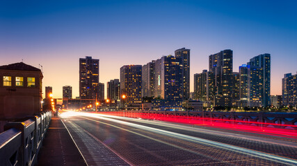 Fototapeta na wymiar Miami city skyline with moving traffic light trails at night, Florida