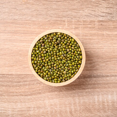 Mung bean seeds in a bowl on wooden background, Food ingredients in Asian cuisine and produce mung bean sprout