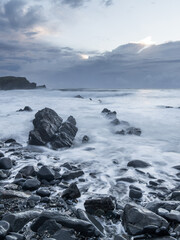 Fototapeta na wymiar Rocky seascape view in cloudy morning.