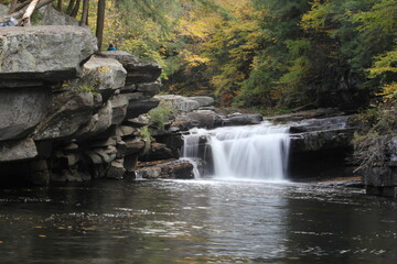 Colorful Vermont autumn foliage waterfall down the river in the forest