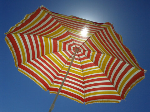 Low Angle View Of Umbrella Against Blue Sky