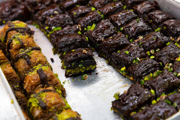 Traditional turkish dessert baklava with peanuts on a metal tray