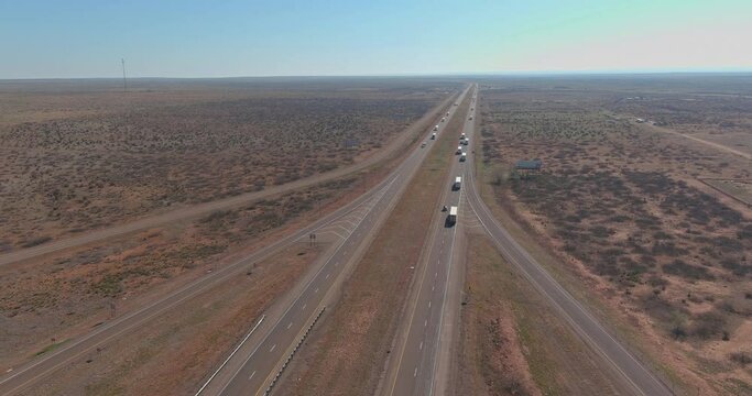 Scenic highway a cargo truck enduring through desert landscape of near San Jon New Mexico USA