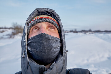 Fototapeta na wymiar Frozen man in winter clothes, cold, frost