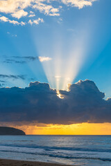 Sunrise seascape with clouds and sun rays