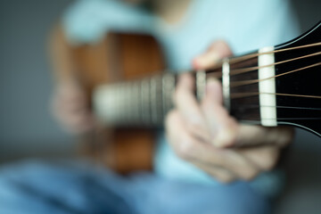 Fototapeta premium Blurred photo of a man playing acoustic guitar for background