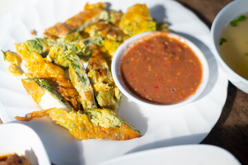 Thai omelette with acacia leaves served with shrimp paste sauce