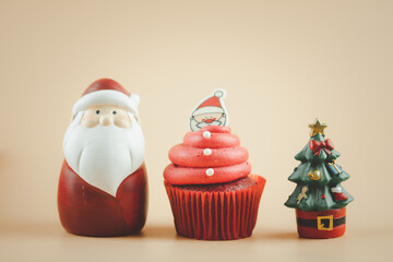Santa cupcake with Santa doll and Christmas tree. Holiday Background