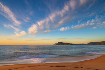 Sunrise seascape with scattered high cloud