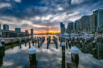 Scenic view of the Docklands harbor during sunset in Melbourne Australia - obrazy, fototapety, plakaty