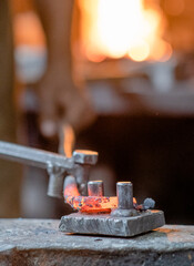 blacksmith working metal on the anvil in the forge