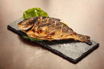 Grilled dorada servel lemon slice