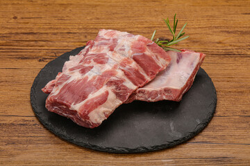 Raw pork ribs served rosemary