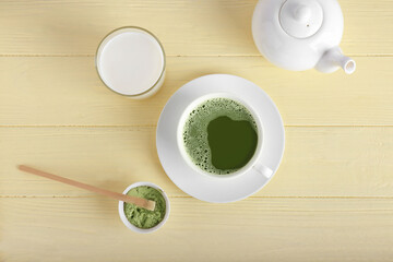 Fototapeta na wymiar Composition with cup of matcha tea and powder on color wooden background