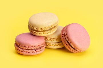 Multi-colored macarons in a line on a light background. Close-up, copy space.