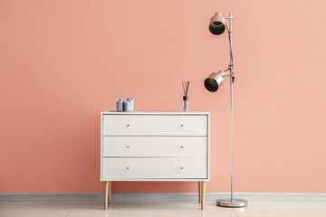 Chest of drawers and lamp in interior of modern room