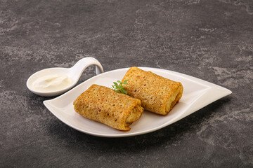 Staffed pancakes served sour cream