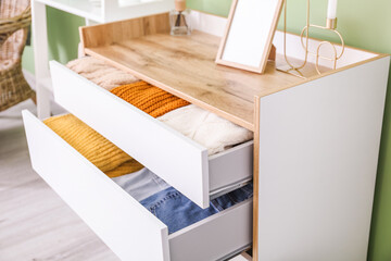 Modern chest of drawers in room, closeup