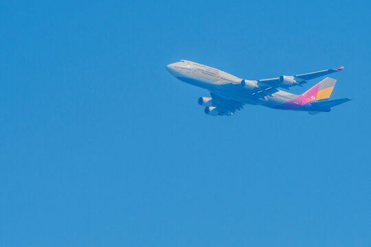 Asiana Airlines 747 In Flight In Hazy Blue Sky.