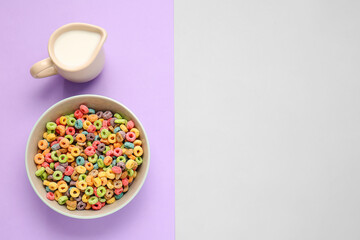 Bowl with cereals and jug of milk on color background