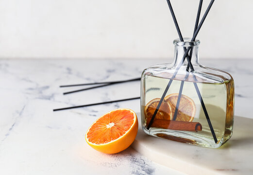 Citrus reed diffuser with cinnamon on light background