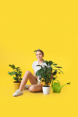 Young female gardener on color background