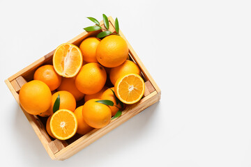 Box with tasty oranges on white background