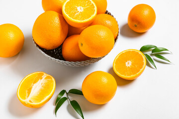 Bowl with oranges on white background