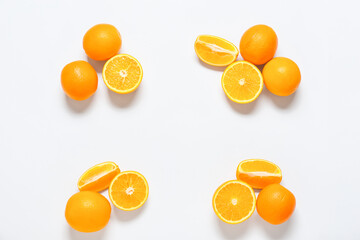 Ripe tasty oranges on white background