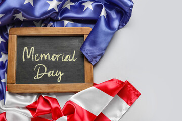 Chalkboard with text MEMORIAL DAY and USA flag on grey background