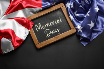 Chalkboard with text MEMORIAL DAY and USA flag on dark background
