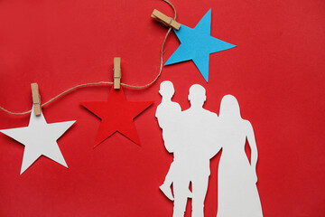 Figure of family and stars in colors of USA flag on color background
