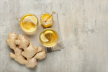 Cups of tea with ginger and honey on grunge background