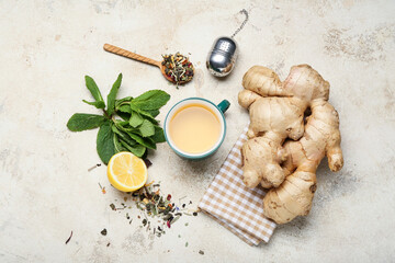 Cup of tea with ginger, mint and lemon on light background