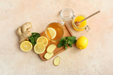 Fototapeta na wymiar Cup of tea with ginger, honey and lemon on color background