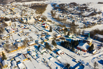 Aerial view of snow covered Venyov townscape with architectural ensemble of Orthodox church of Our Lady of Kazan and Epiphany church in winter, Tula Oblast, Russia