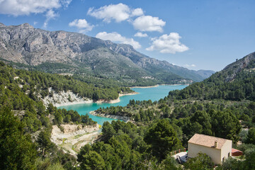 Fototapeta premium An idyllic lake between mountains. A famous city Guadalest reservoir in Alicante, Spain.